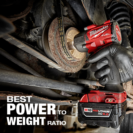 Mechanic wearing glove uses mid-torque impact wrench to work on vehicle.